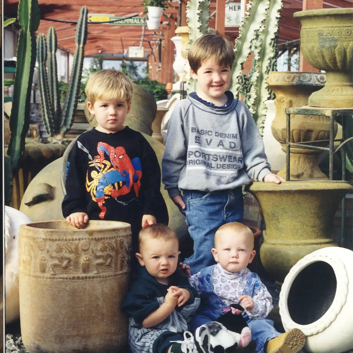 Four of Adrian's grandchildren ranging in age, posing with cast iron pot collection.