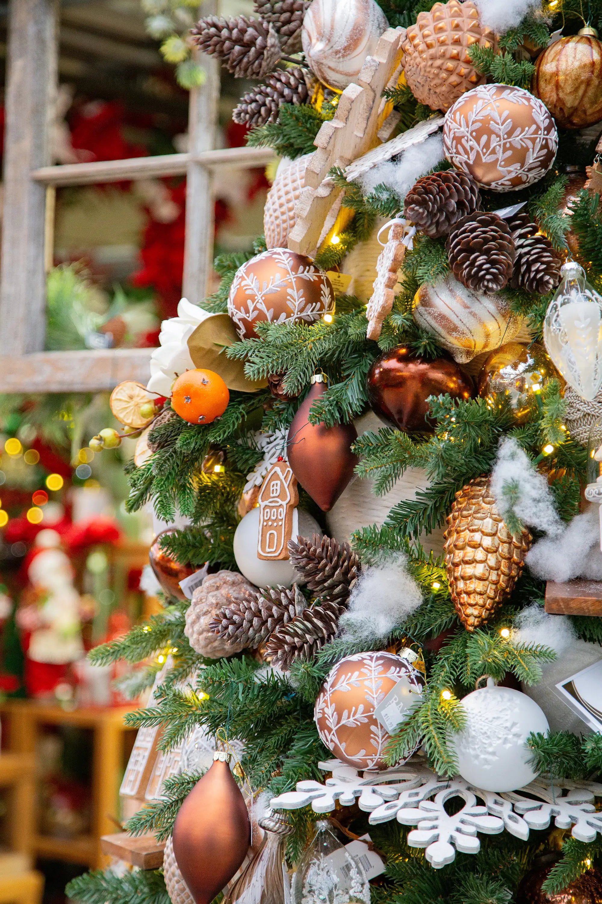 Designer-decorated Christmas tree with gingerbread-themed ornaments in a festive setting